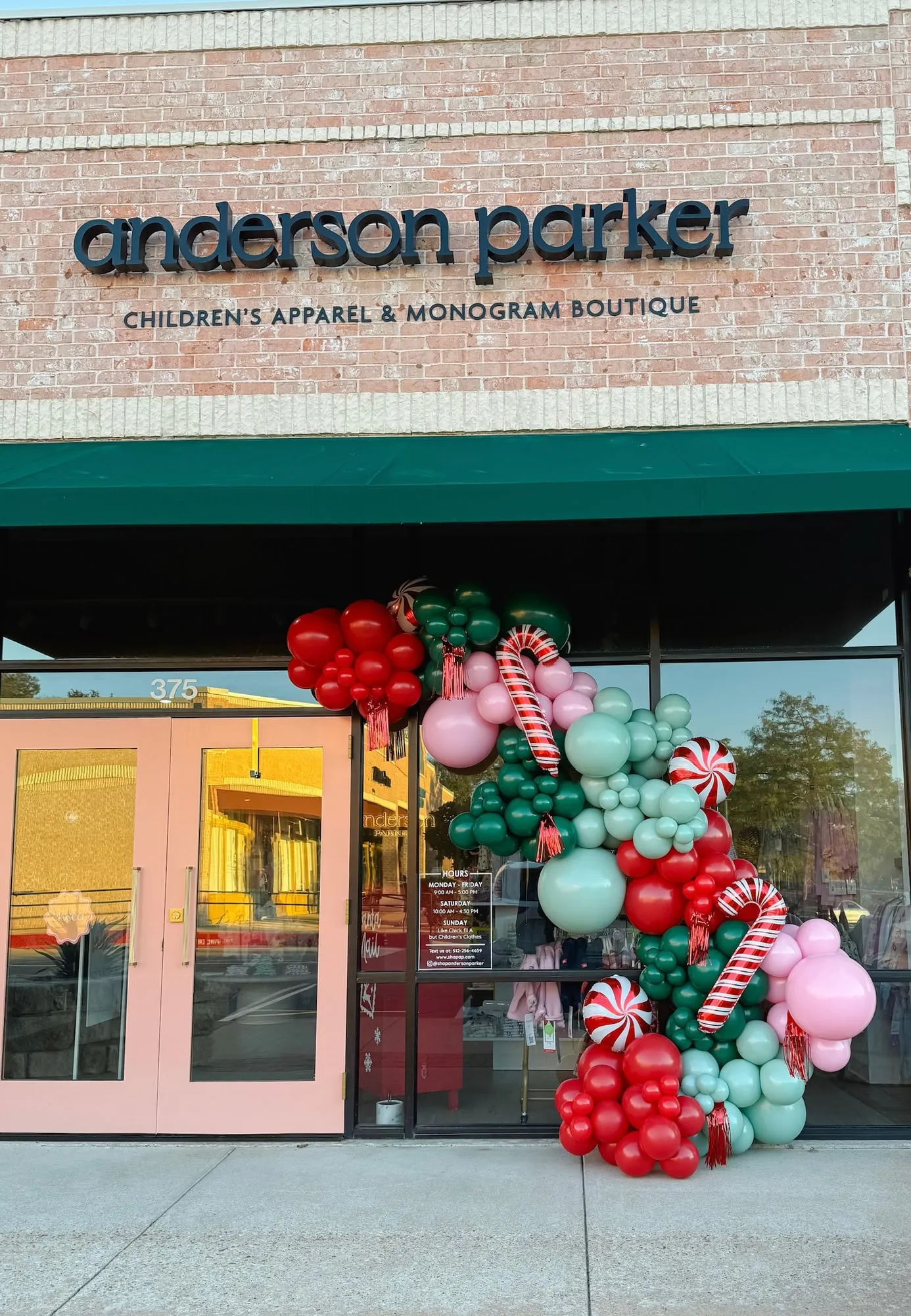 Christmas balloon garland with candy cane and peppermint balloons on the Anderson Parker boutique storefront