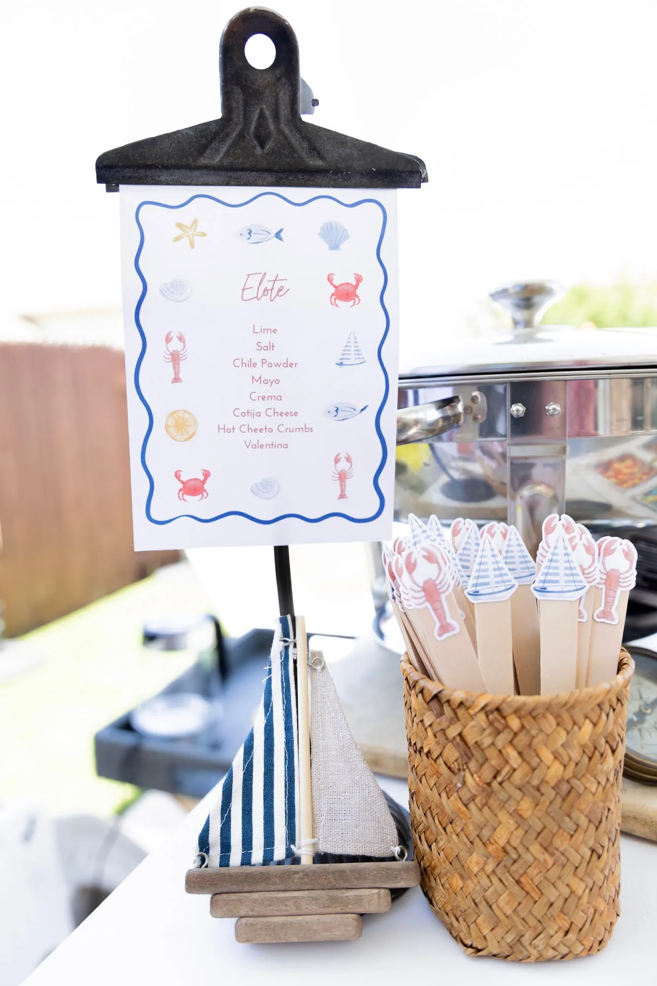 Custom nautical elote bar menu sign with sailboat and lobster drink stirrers