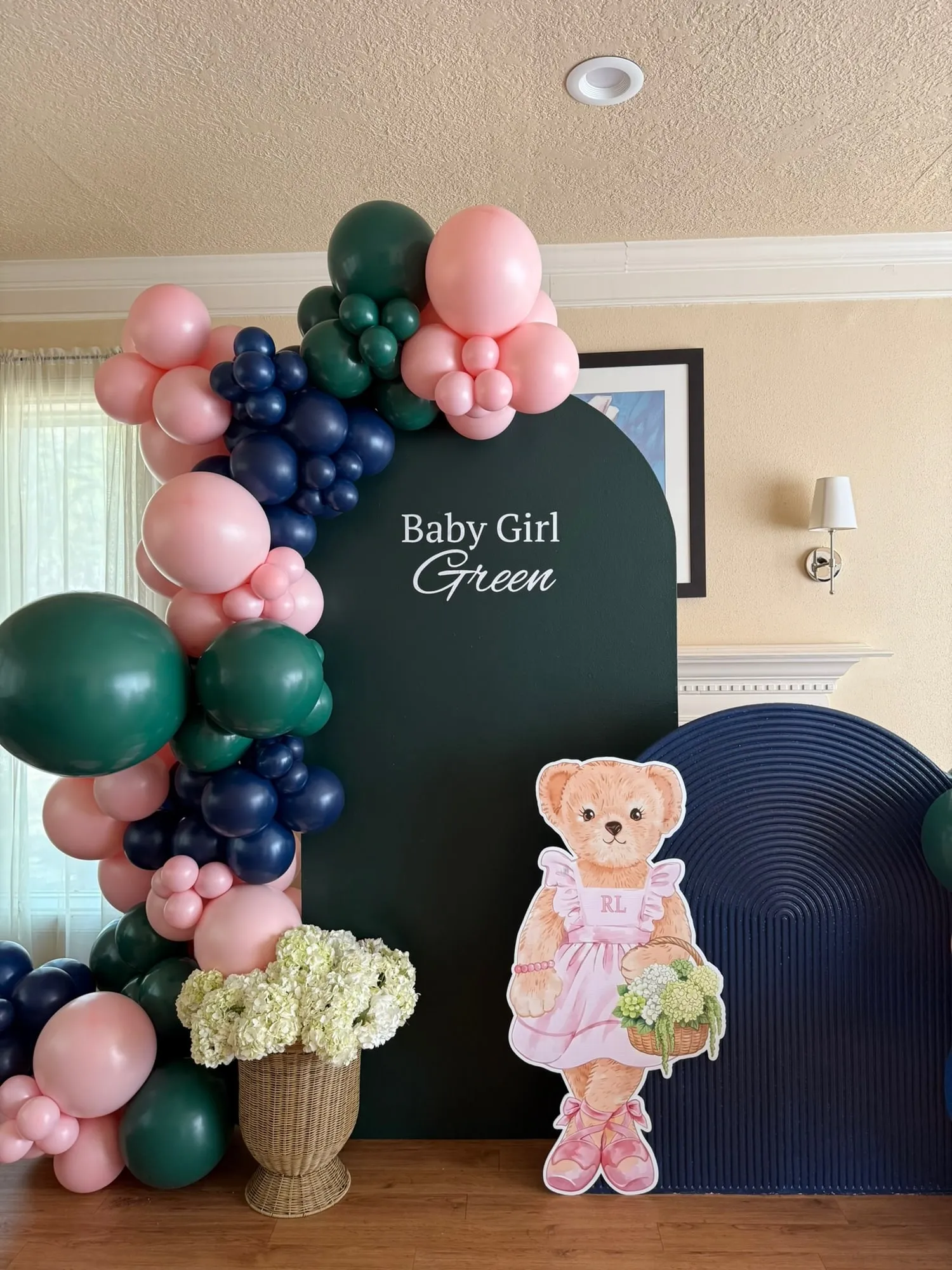 Baby girl shower with a hunter green arch, navy fluted panel, ballerina bear cutout and pink, green and navy balloon garland