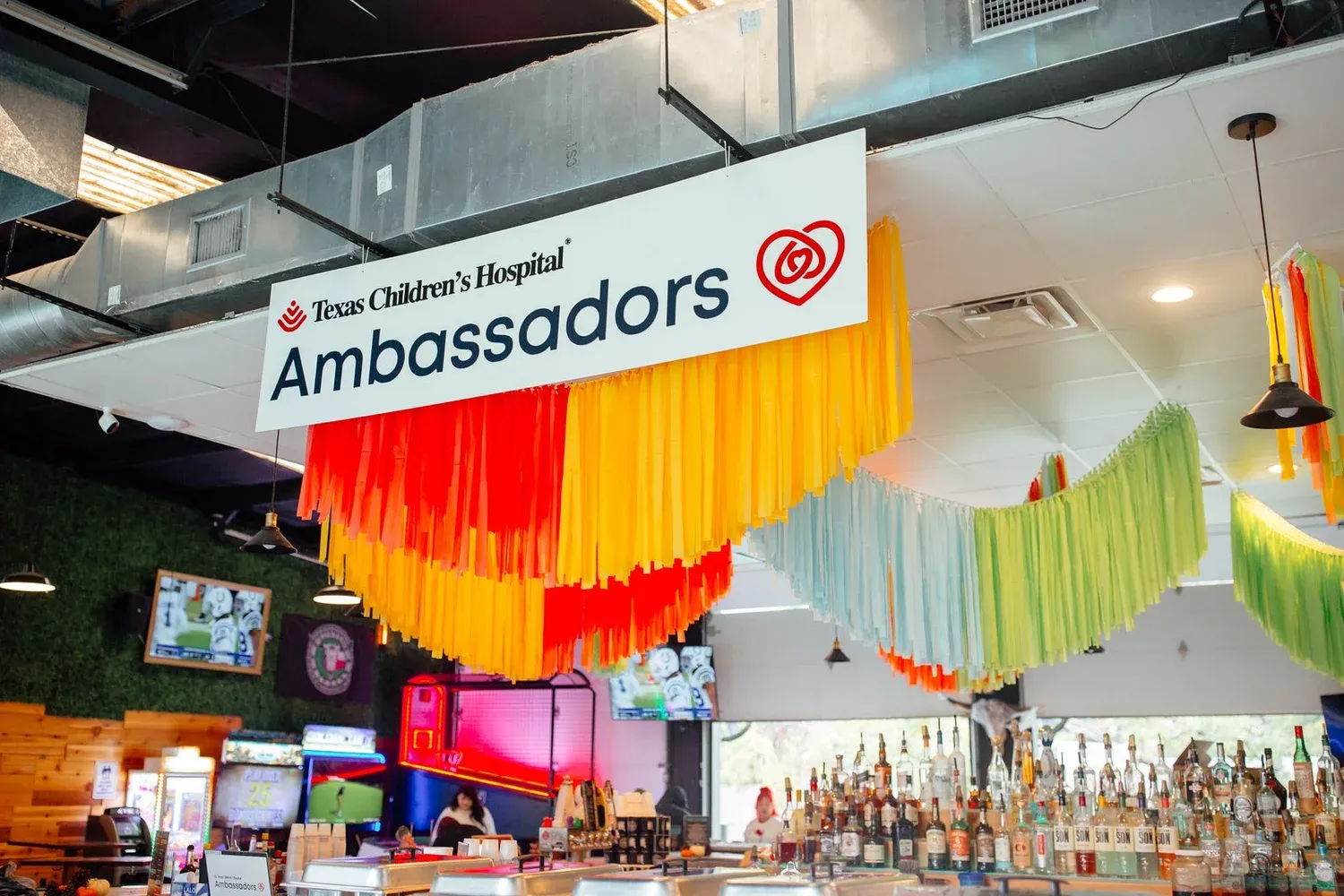Rainbow streamer fringe ceiling installation for a Texas Children’s Hospital event